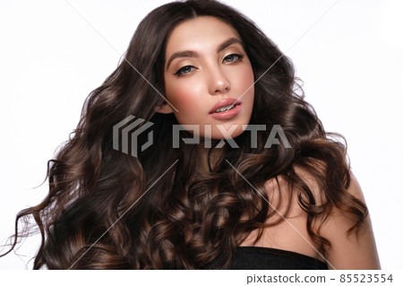 Beautiful brown-haired girl with a perfectly curls hair, and classic make-up. Beauty face and hair. 85523554