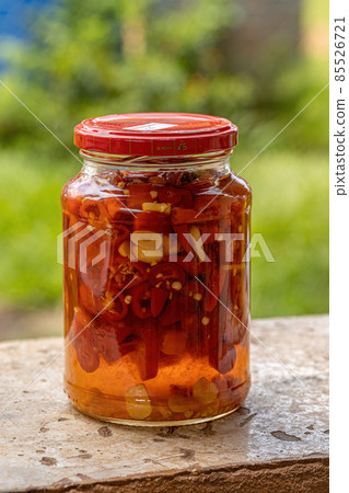 Itaja, Goias, Brazil - 12 24 2021: Canned jar of pissed off peppercorns tanned in lemon Itaja, Goias, Brazil - 12 24 2021: Canned jar of pissed off peppercorns tanned in lemon 85526721