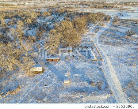 abandoned farm and river at winter sunset 85526903