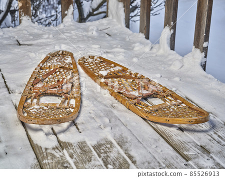 Classic wooden snowshoes in a backyard Classic wooden snowshoes in a backyard 85526913