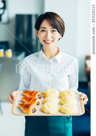 Middle-aged woman working in a bakery 85528315