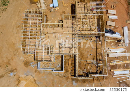 Aerial view the a new house under construction wood framing beams Aerial view the a new house under construction wood framing beams 85530175