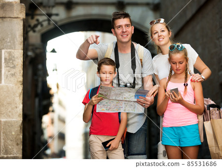 Parents and kids traveling together using paper map Parents and kids traveling together using paper map 85531686