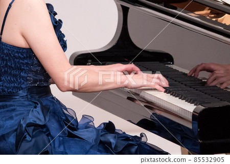 At the hands of a female pianist playing a concert grand piano At the hands of a female pianist playing a concert grand piano 85532905