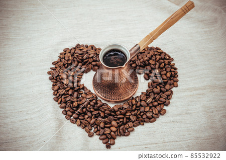 Coffee turk and roasted beans on burlap background. Coffee turk and roasted beans on burlap background. 85532922