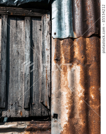 Old and rusty zinc sheet wall. Vintage style metal sheet roof texture. Pattern of old metal sheet. Rusting metal or siding. Corrosion of galvanized. Background and textures in retro concept. Old and rusty zinc sheet wall. Vintage style metal sheet roof texture. Pattern of old metal sheet. Rusting metal or siding. Corrosion of galvanized. Background and textures in retro concept. 85534212