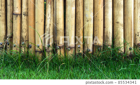 Old brown tone bamboo simple wall or Bamboo fence texture background for exterior design vintage tone. Brown bamboo stick pattern backdrop. Local area urban house protection from thief. Old brown tone bamboo simple wall or Bamboo fence texture background for exterior design vintage tone. Brown bamboo stick pattern backdrop. Local area urban house protection from thief. 85534341