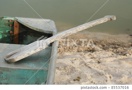 Old Boat and Paddle, Vintage Canoe on Small Lake Old Boat and Paddle, Vintage Canoe on Small Lake 85537016