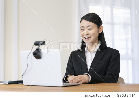 Image of a young woman talking to a webcam online interview video call 85538414