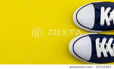 casual sports shoes in blue on a yellow background 85538895