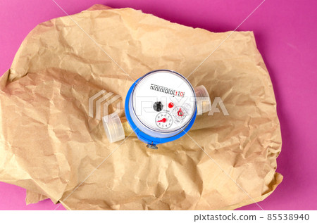 New water meter in wrap-around paper opposite magenta background New water meter in wrap-around paper opposite magenta background 85538940