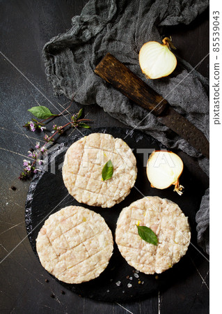 Raw fresh cutlets burger from beef for homemade burgers cooking with spices on black board. Top view. Free space for your text. 85539043