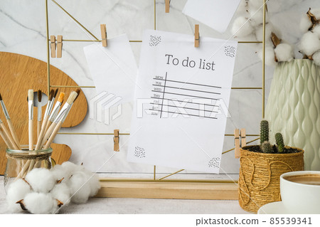 TO DO list cards and posters mock ups on grid board. Copy space. Home office desktop. Freelance bloggers workplace. Brushes and palette 85539341