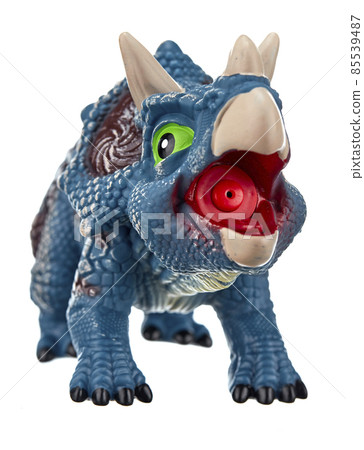 Toy dinosaur of bluish color with green eyes, an open mouth and horns on its head, isolated on a white background. 85539487