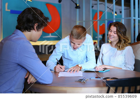 Young couple buy apartment with realtor contract Young couple buy apartment with realtor contract 85539609