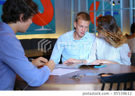 Young couple buy apartment with realtor contract 85539612