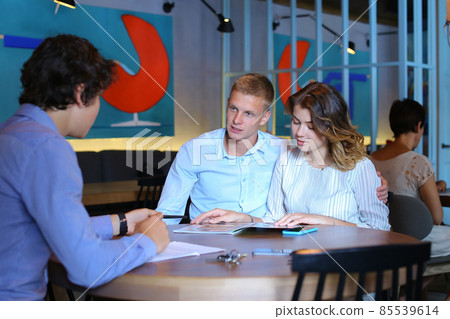 Young couple buy apartment with realtor contract Young couple buy apartment with realtor contract 85539614