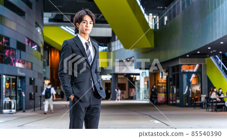 A businessman standing on a pedestrian bridge, Shibuya 85540390