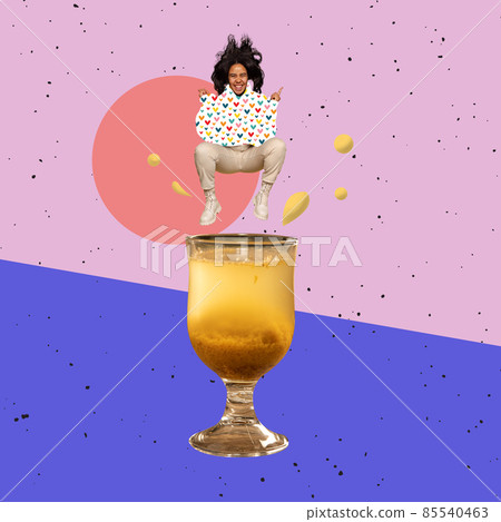 Contemporary art collage, modern design. Party mood. Young happy girl jumping into cocktail glass with hot drink Contemporary art collage, modern design. Party mood. Young happy girl jumping into cocktail glass with hot drink 85540463