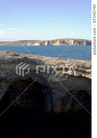 MARSAXLOKK, MALTA - 01 JAN, 2020: Beautiful Coral Lagoon with caves MARSAXLOKK, MALTA - 01 JAN, 2020: Beautiful Coral Lagoon with caves 85540740