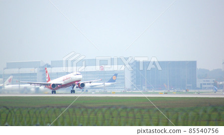 MUNICH, GERMANY - 11 OCTOBER 2015: Passenger plane of Air Berlin low-cost airline touching down runway at Munich international airport MUC MUNICH, GERMANY - 11 OCTOBER 2015: Passenger plane of Air Berlin low-cost airline touching down runway at Munich international airport MUC 85540756