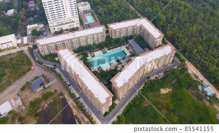 Aerial view of swimming pool on rooftop of hotel resort, apartment building with forest trees, urban city town. Relaxing in summer season in travel holiday vacation concept. Recreation lifestyle. Aerial view of swimming pool on rooftop of hotel resort, apartment building with forest trees, urban city town. Relaxing in summer season in travel holiday vacation concept. Recreation lifestyle. 85541155