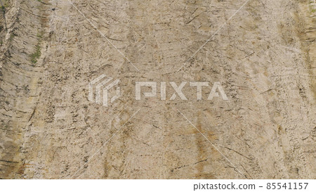 Aerial top view of dry ground rough cracks in the land with sand in paddy rice field. serious water shortages and Drought barren arid pattern texture background. Aerial top view of dry ground rough cracks in the land with sand in paddy rice field. serious water shortages and Drought barren arid pattern texture background. 85541157