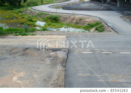 Unfinished road in the countryside of Thailand. Unfinished road causes from road condition, bad terrain or maybe government corruption. 85541263