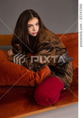 Dark hair young woman with dark grey wall behind Dark hair young woman with dark grey wall behind 85543560