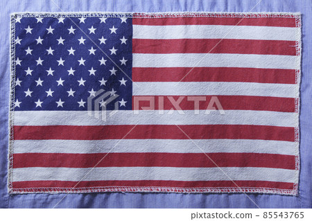 USA flag on fabric texture sewn to blue fabric USA flag on fabric texture sewn to blue fabric 85543765