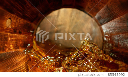 Freeze motion of splashing whisky in barrel Freeze motion of splashing whisky in barrel 85543992