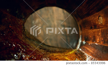 Freeze motion of splashing whisky in barrel Freeze motion of splashing whisky in barrel 85543996