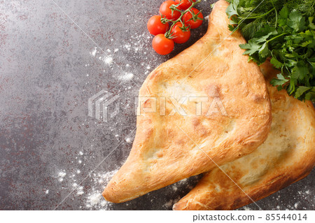 Georgian traditional bread Shotis puri close-up. horizontal top view Georgian traditional bread Shotis puri close-up. horizontal top view 85544014