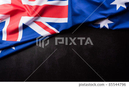 Happy Australia day concept. Australian flag against dark stone background. 26 January. Happy Australia day concept. Australian flag against dark stone background. 26 January. 85544796
