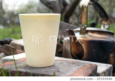 White cup, old grunge teapot outdoors picnic mood 85544946