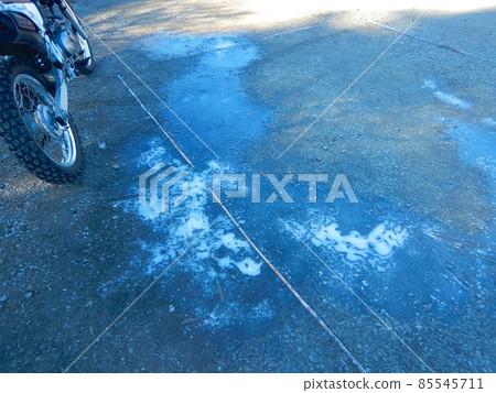 Frozen puddle in the parking lot 85545711