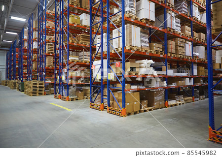 Interior of a modern warehouse storage of retail shop with pallet truck near shelves 85545982