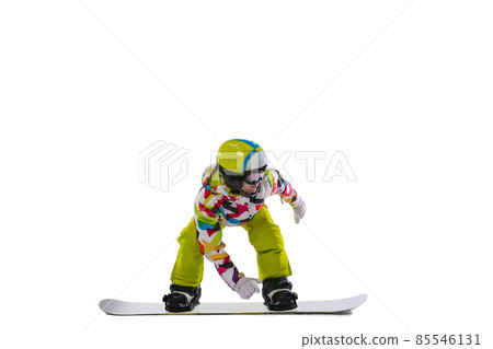 One young woman in bright sportswear, goggles and helmet snowboarding isolated on white studio background. Concept of winter sports 85546131