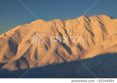 Snowy mountain at sunset Tateyama Snowy mountain at sunset Tateyama 85546984