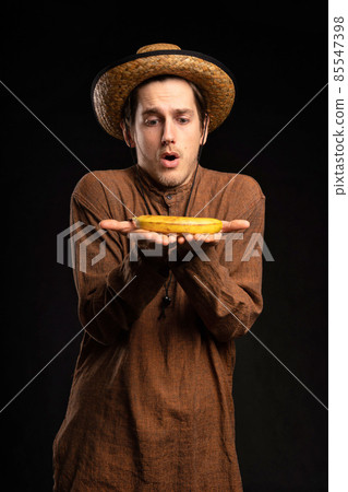 Young man with banana on black Young man with banana on black 85547398