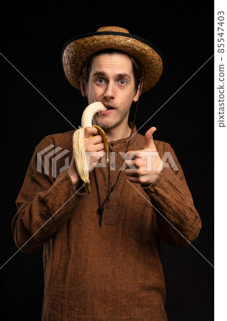 Young man with banana on black 85547403