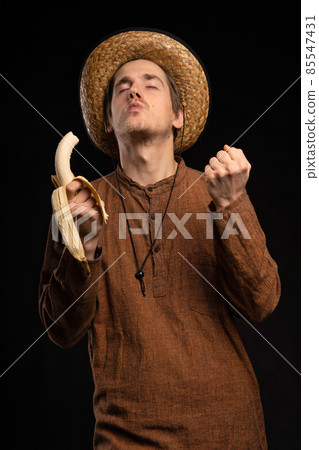 Young man with banana on black 85547431