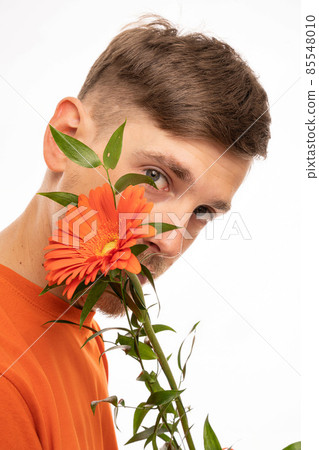 Young man with flower on white Young man with flower on white 85548010