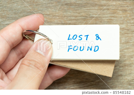 Man hold the flash card with handwriting word lost and found on wood background Man hold the flash card with handwriting word lost and found on wood background 85548182