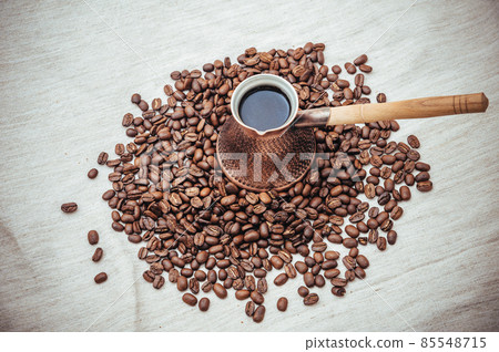 Coffee turk on burlap background. coffee beans isolated on white background. roasted coffee beans Coffee turk on burlap background. coffee beans isolated on white background. roasted coffee beans 85548715