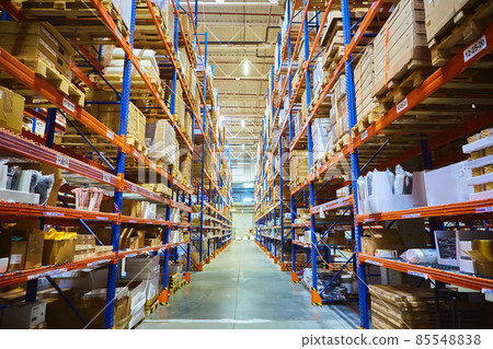 Huge distribution warehouse with high shelves and loaders. 85548838