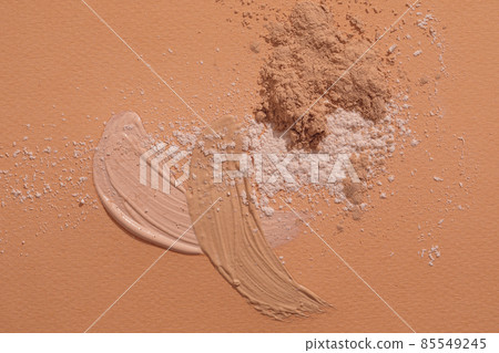 Crashed beige face finishing and liquid powder. Macro texture of make-up on beige background 85549245