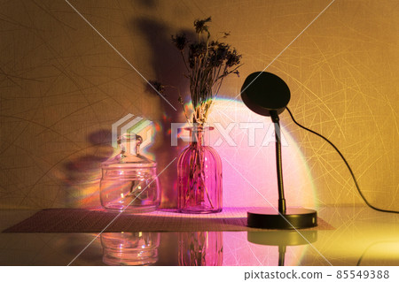 Sunset projector lamp on the table. Multi colored RGB light. Home decor. Selective focus 85549388