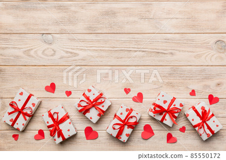Valentine day composition: red gift box with bow and heart. Christmas present. View from above. Space for text. Holday greeting card Valentine day composition: red gift box with bow and heart. Christmas present. View from above. Space for text. Holday greeting card 85550172