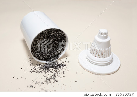 Cut filter for water purification. Replacement filter jug cartridge. Filter material made of carbon and white granules. Granular coal Cut filter for water purification. Replacement filter jug cartridge. Filter material made of carbon and white granules. Granular coal 85550357